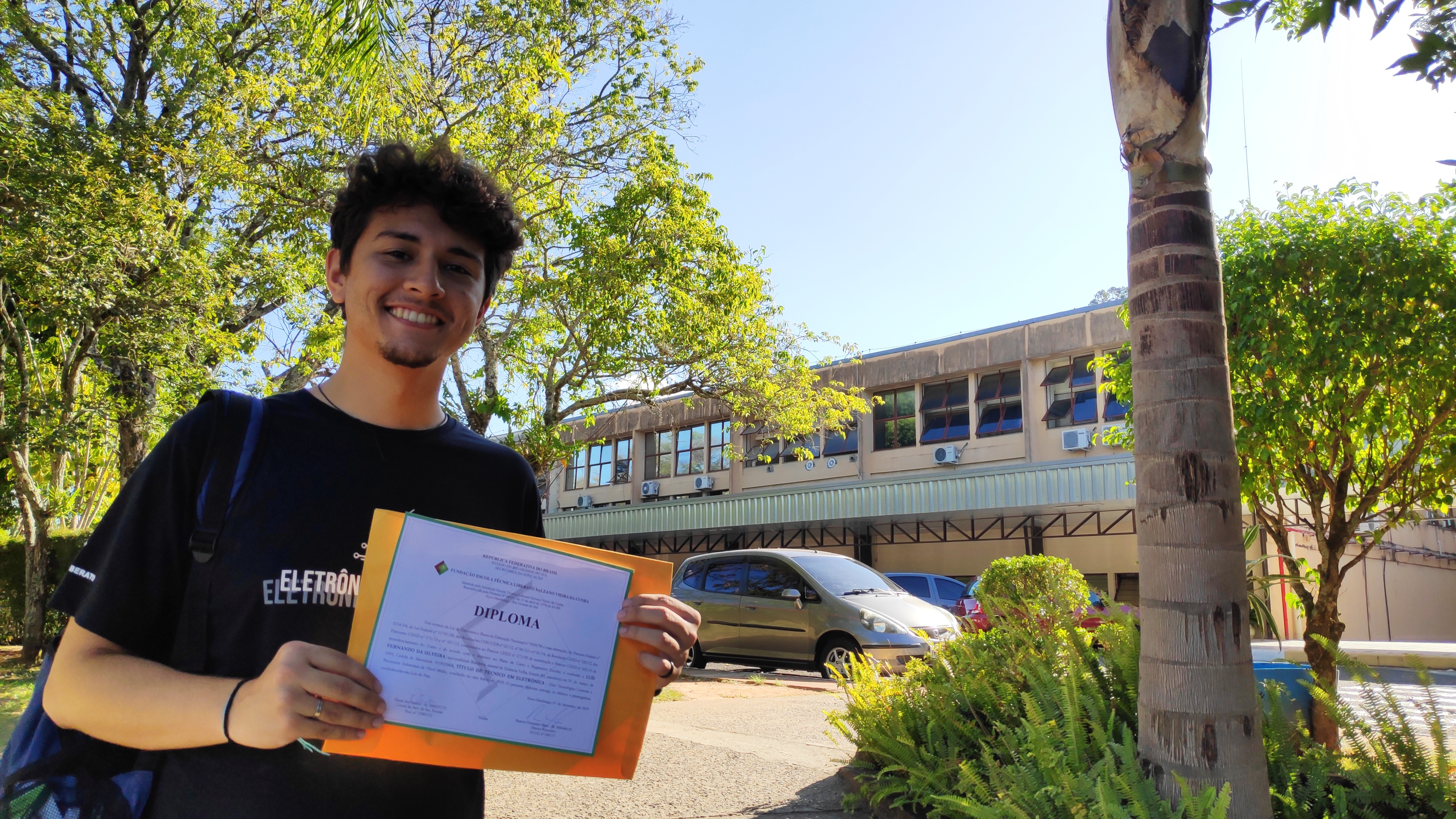Luís with his technical diploma in front of his school